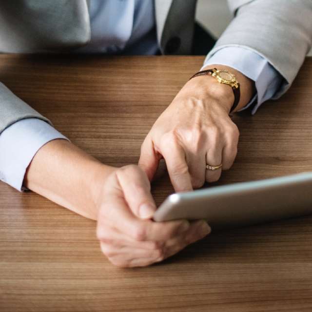 Woman using Conga Automate Revenue Suite on tablet