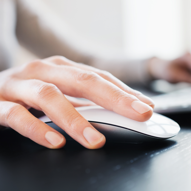 Closeup of a woman's hand on computer mouse