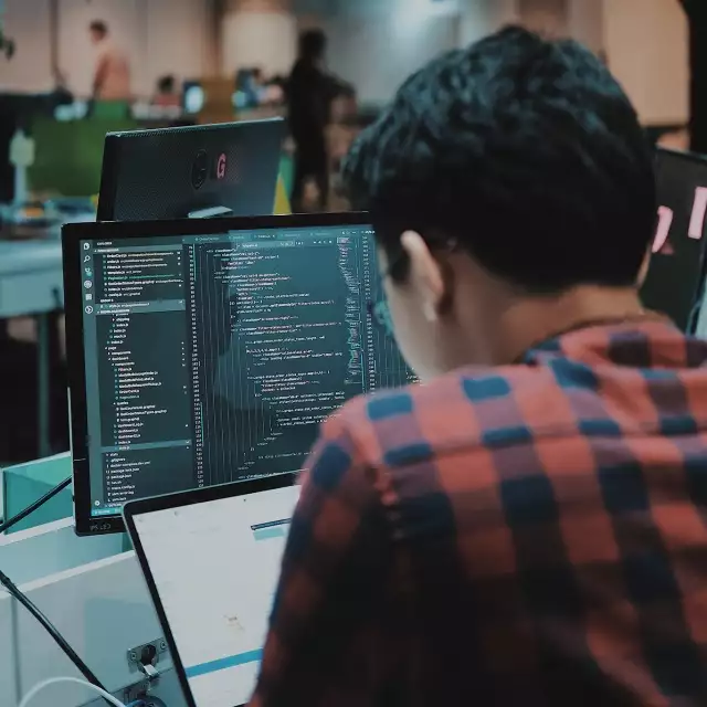 Man working on code on a computer