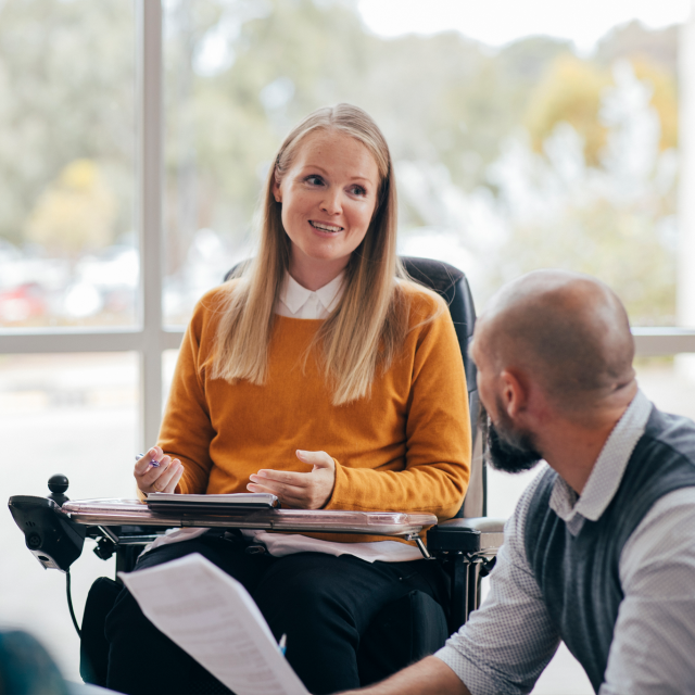 Woman in a wheelchair having a meeting with a man