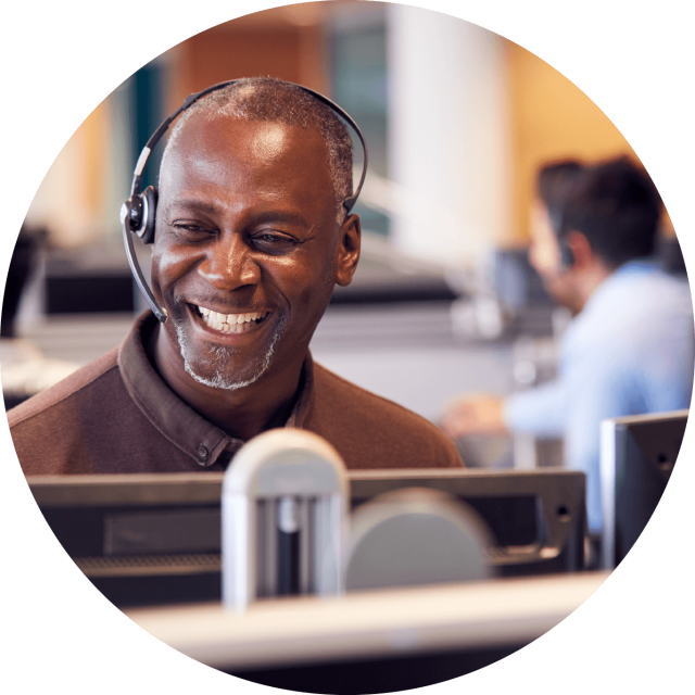 Man smiling while talking into headset
