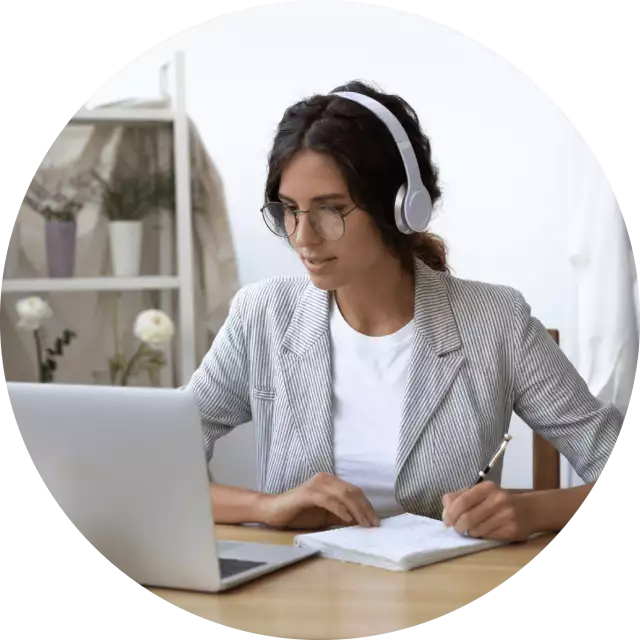 Woman wearing headphones staring at laptop