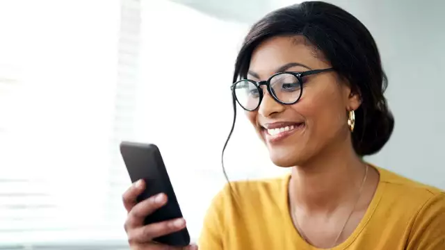 Woman smiling on cell phone