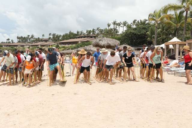 The Conga team participates in a team race on the beach