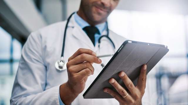 Doctor writing notes on tablet