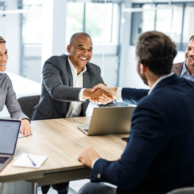 Men shaking hands in office