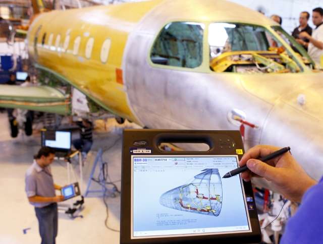 Engineer looking at airplane design on tablet