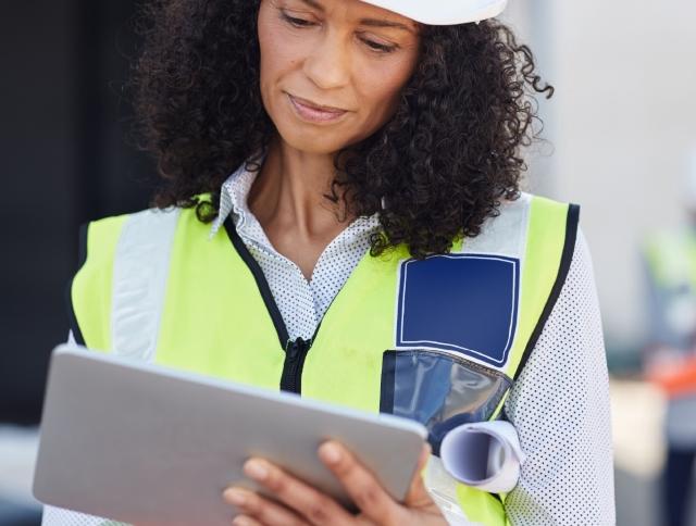 Construction woman looking at tablet