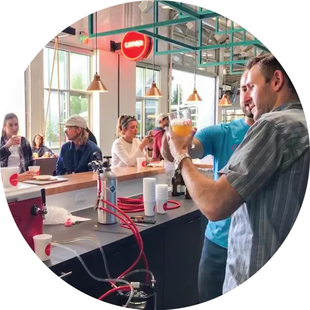 Conga employees drinking beer at the office bar