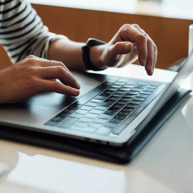 Man typing on laptop while using Conga CLM