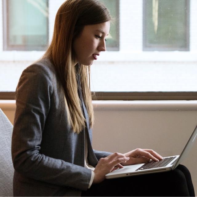 Woman using Conga Automate Revenue Suite on laptop