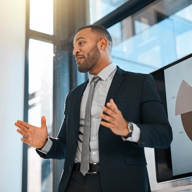 Man giving a presentation on the benefits of Conga's Revenue Automation Suite