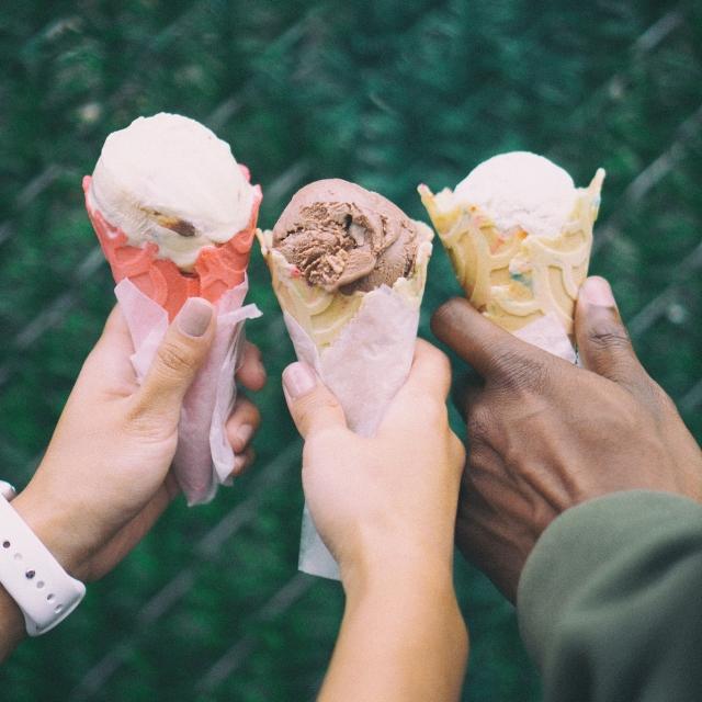 Three people holding ice cream cones