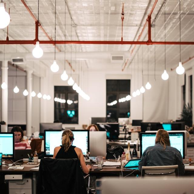 Employees working in large modern office