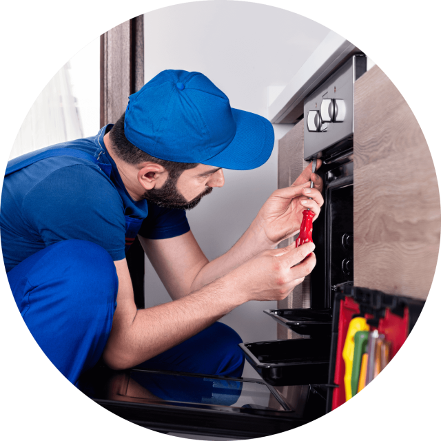 Workman fixing an oven