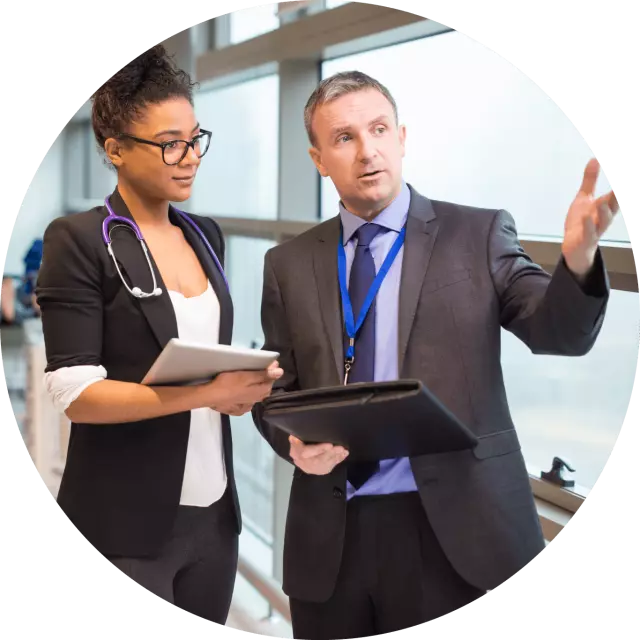 A doctor talking to a man in a suit