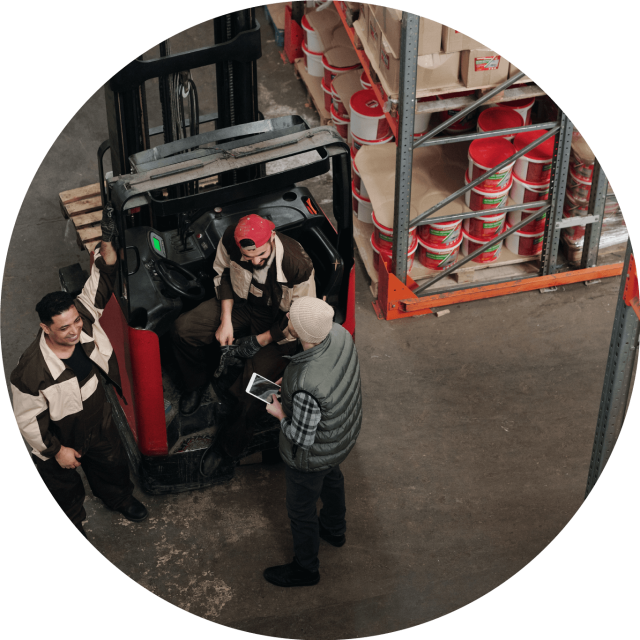 Three men working in a warehouse
