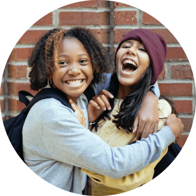 Two kids embracing and lauging