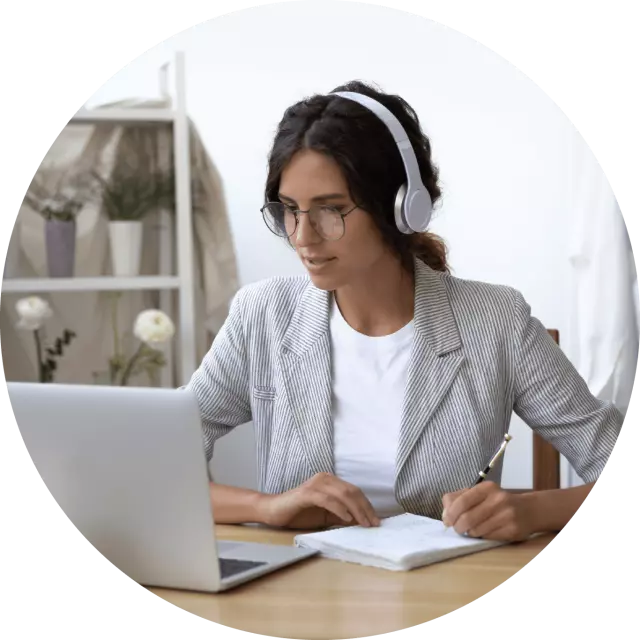 Woman wearing headphones staring at laptop