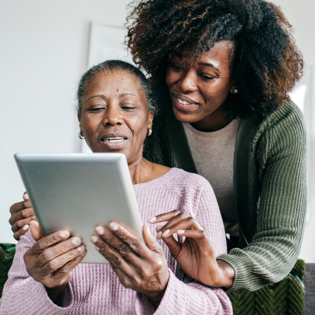 Mom and daughter looking at tablet