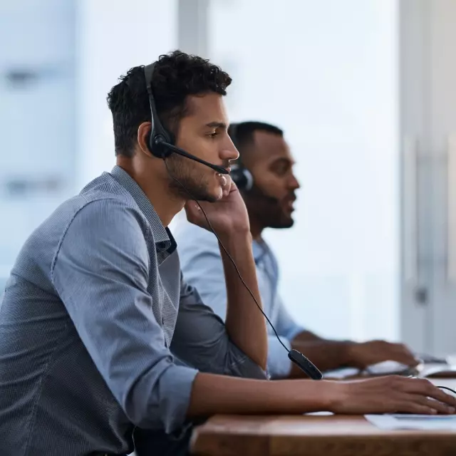 Two salesmen on headsets