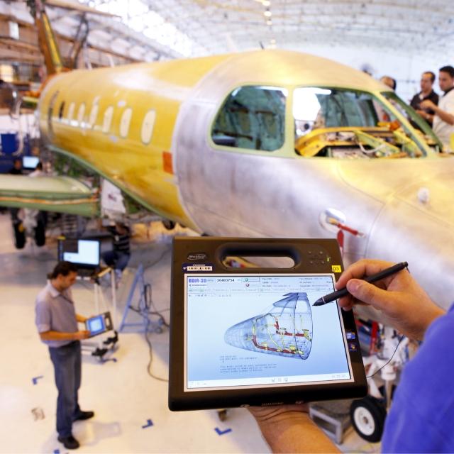 Engineer looking at airplane design on tablet