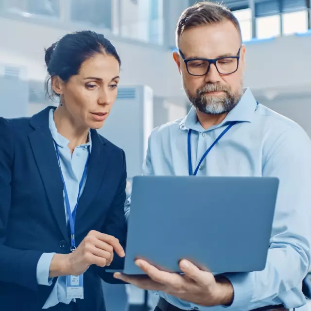 Man and woman looking at laptop