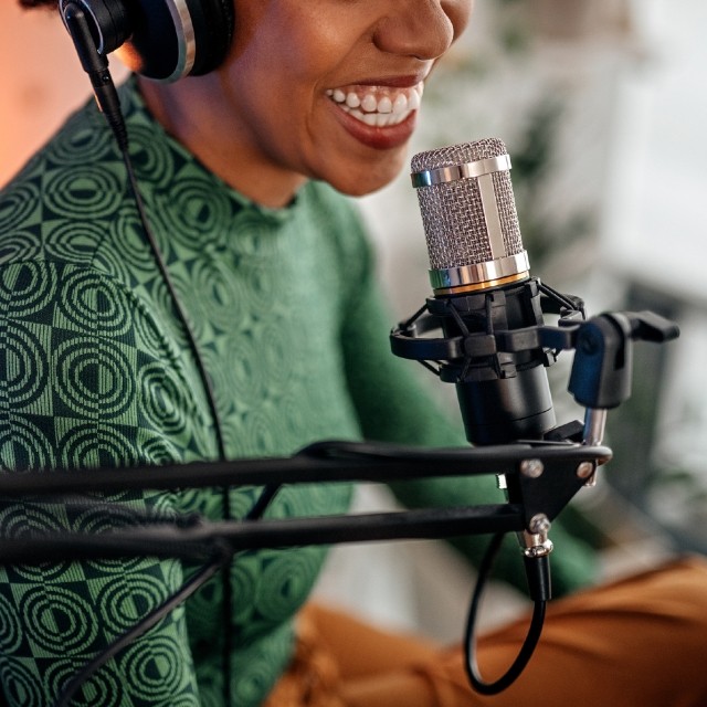 Woman speaking into recording microphone