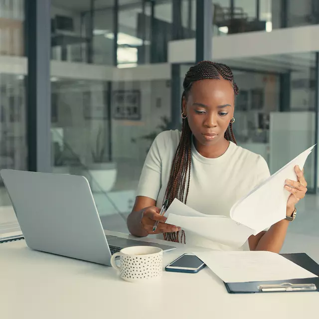 Woman sitting at table reviewing contract