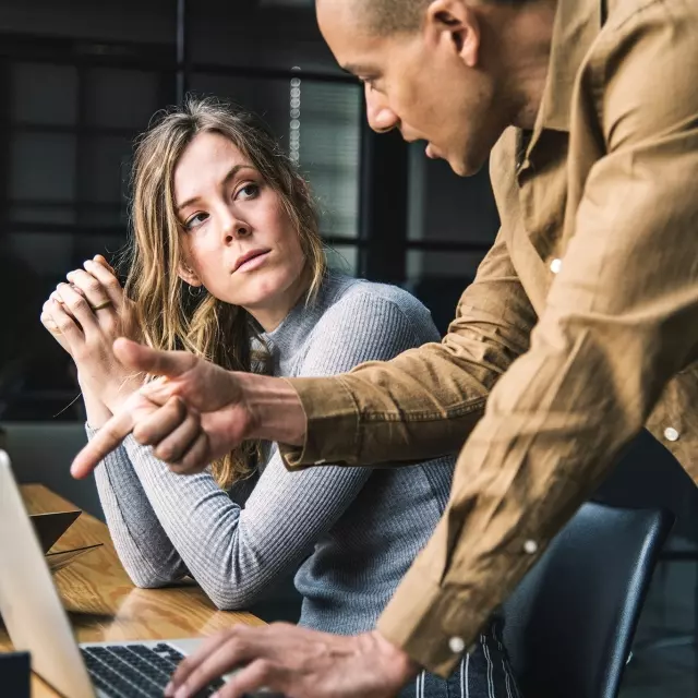 Woman and man talking in office