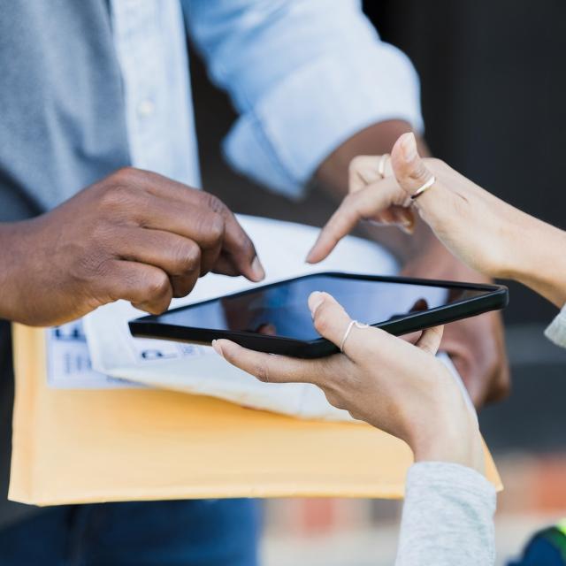 Person signing a contract on a tablet