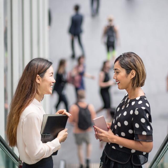 Two women talking in workplace