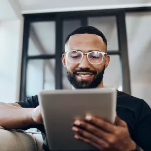 Man looking at contract analytics on tablet
