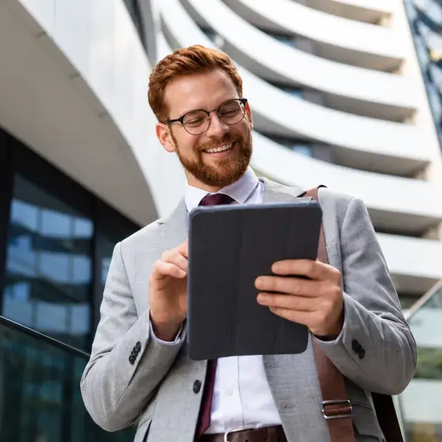 Man using a tablet outdoors.