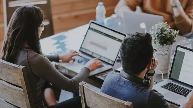 Employees working on computers in office