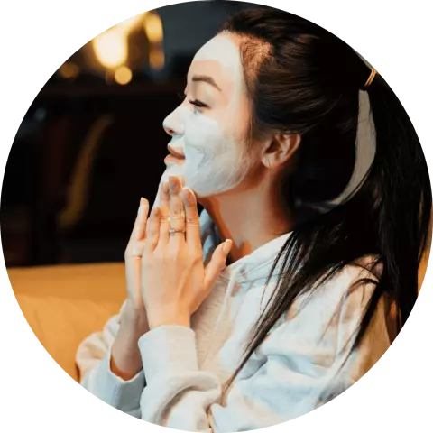 Young woman applying a face mask