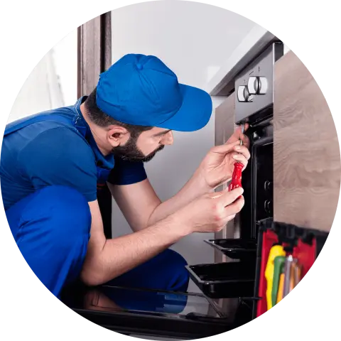 Workman fixing an oven