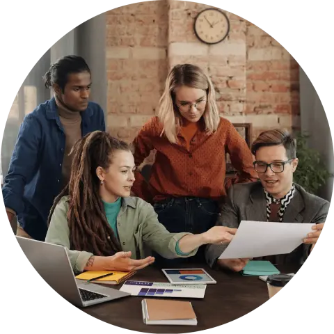Four people looking over a document