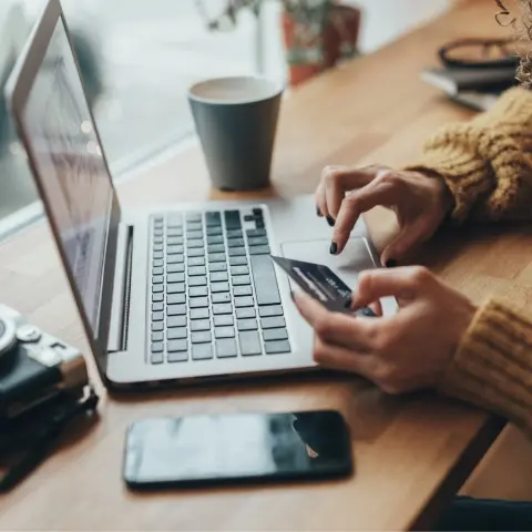 Woman entering credit card information on laptop