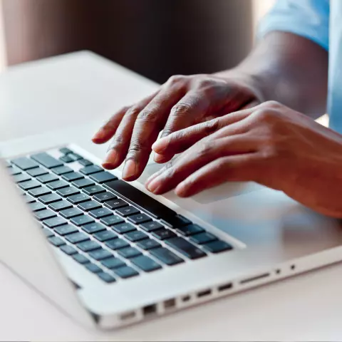 Close up of hands typing