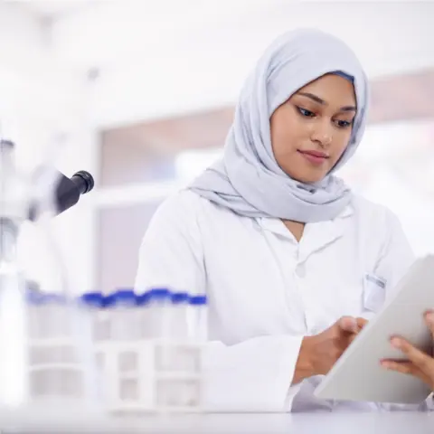 Woman in lab using tablet