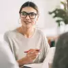 Woman holding a pencil and smiling