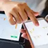 Woman pointing to graphs on phone