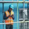 Construction worker using walkie talkie