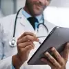 Doctor writing notes on tablet